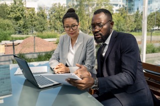 https://upstaterecruiters.com/wp-content/uploads/2024/06/african-businessman-showing-paper-asian-female-partner-Small.jpeg